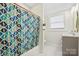 Stylish bathroom featuring a patterned shower curtain, window, and a modern vanity at 600 3Rd St, Spencer, NC 28159