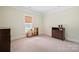 Neutral bedroom features a window and classic trim at 600 3Rd St, Spencer, NC 28159