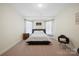 Serene bedroom with large windows, neutral decor, and a cozy ambiance at 600 3Rd St, Spencer, NC 28159
