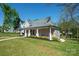Charming single-Gathering home with a well-maintained lawn, inviting porch, and classic architectural design at 600 3Rd St, Spencer, NC 28159