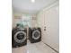 Bright laundry room boasts a new, modern, front-loading washer and dryer at 600 3Rd St, Spencer, NC 28159