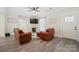 Comfortable living area with leather seating, ceiling fan, and ample natural light from the nearby entryway at 600 3Rd St, Spencer, NC 28159