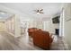 Cozy living room showcasing hardwood floors, leather furniture, and a seamless connection to the kitchen at 600 3Rd St, Spencer, NC 28159