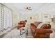 Warm living room features leather furniture, hardwood floors, and an open layout to the kitchen area at 600 3Rd St, Spencer, NC 28159
