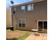 Backyard featuring an exterior wall with windows, an AC unit, patio and small table at 616 Mountain Quail Dr, Charlotte, NC 28216