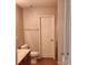 Neutral bathroom featuring a toilet, sink, cabinets, towel rack, and ceramic tile flooring at 616 Mountain Quail Dr, Charlotte, NC 28216