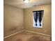 Bedroom with neutral walls and carpet, with a window with black curtains at 616 Mountain Quail Dr, Charlotte, NC 28216