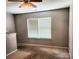 Bedroom featuring neutral carpet, a ceiling fan, and a large window with blinds at 616 Mountain Quail Dr, Charlotte, NC 28216