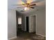 A bedroom with neutral walls and carpet, with two doorways and a window at 616 Mountain Quail Dr, Charlotte, NC 28216