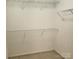 Walk-in closet with shelving and beige carpet at 616 Mountain Quail Dr, Charlotte, NC 28216