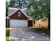 Charming two-story home with a brick facade, a two-car garage, and a well-maintained front yard at 616 Mountain Quail Dr, Charlotte, NC 28216