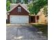 Charming two-story home with a brick facade, a two-car garage, and a well-maintained front yard at 616 Mountain Quail Dr, Charlotte, NC 28216