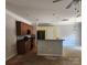 Kitchen with wood cabinets, stainless steel appliances, and a peninsula counter at 616 Mountain Quail Dr, Charlotte, NC 28216