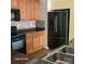 Functional kitchen featuring wood cabinets, stainless steel appliances, and a tile backsplash at 616 Mountain Quail Dr, Charlotte, NC 28216
