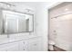 Bathroom with double sink vanity and shower over tub featuring bright white tile at 6223 Rockwell W Blvd, Charlotte, NC 28269