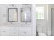 Well-lit bathroom featuring a double sink vanity with framed mirrors, complemented by a modern design and fixtures at 6223 Rockwell W Blvd, Charlotte, NC 28269