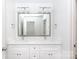 Bathroom featuring double sink vanity with a large mirror and modern lighting fixtures at 6223 Rockwell W Blvd, Charlotte, NC 28269