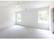 This is a bright, carpeted bedroom with big windows and neutral paint, creating a serene and comfortable living space at 6223 Rockwell W Blvd, Charlotte, NC 28269