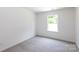 Bright bedroom with plush carpeting and a large window providing ample natural light at 6223 Rockwell W Blvd, Charlotte, NC 28269