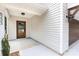 Inviting entryway featuring a wood-look door, modern lighting, and a charming exterior at 6223 Rockwell W Blvd, Charlotte, NC 28269