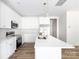 Modern kitchen with stainless steel appliances, white cabinets, and quartz countertops at 6223 Rockwell W Blvd, Charlotte, NC 28269