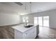 Kitchen island featuring a stainless steel sink, white cabinetry, and recessed lighting at 6223 Rockwell W Blvd, Charlotte, NC 28269