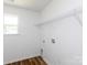 A well-lit laundry room is equipped with essential utility connections and a practical wire shelf for organized storage at 6223 Rockwell W Blvd, Charlotte, NC 28269