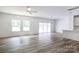Open-concept living room featuring luxury vinyl plank flooring, recessed lighting, and ample windows at 6223 Rockwell W Blvd, Charlotte, NC 28269