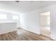 Bright, sunlit loft with sleek hardwood flooring, open space and a doorway leading to an adjacent carpeted room at 6223 Rockwell W Blvd, Charlotte, NC 28269