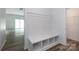 Bright mudroom with built-in bench and storage near the entrance with hardwood floors and bright, neutral paint at 6223 Rockwell W Blvd, Charlotte, NC 28269