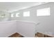 Well-lit staircase with wood flooring and natural light pouring in from several windows at 6223 Rockwell W Blvd, Charlotte, NC 28269