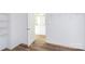 This spacious walk-in closet features open shelving and hardwood floors, providing ample storage and organization options at 6223 Rockwell W Blvd, Charlotte, NC 28269