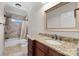 Bathroom featuring granite countertop, tiled shower and floors, plus natural light from the window at 630 Deberry Holw, Rock Hill, SC 29732