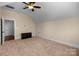Large bedroom with a ceiling fan, neutral tones, carpeted floors, and an adjacent room for added versatility at 630 Deberry Holw, Rock Hill, SC 29732