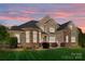 Charming brick and stone home with manicured lawn and pink sunset backdrop at 630 Deberry Holw, Rock Hill, SC 29732