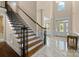Bright foyer with marble floors, elegant staircase, and a view of the front entrance at 630 Deberry Holw, Rock Hill, SC 29732