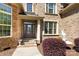 Inviting front entrance with brick and stone accents, potted plants, and elegant glass door at 630 Deberry Holw, Rock Hill, SC 29732