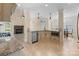 Open kitchen with granite countertops, stainless steel appliances, island, and stone fireplace in adjacent living area at 630 Deberry Holw, Rock Hill, SC 29732