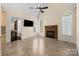 Inviting living room features a stone fireplace, tile flooring, and natural light with views to the backyard at 630 Deberry Holw, Rock Hill, SC 29732