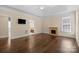 A relaxing main bedroom with hardwood floors, a fireplace, a television, and a view into an ensuite bathroom at 630 Deberry Holw, Rock Hill, SC 29732