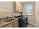 Functional laundry room with modern appliances, granite countertops, and ample cabinet storage space at 630 Deberry Holw, Rock Hill, SC 29732