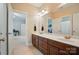 Bathroom featuring double sink vanity with dark wood cabinets and marble countertops at 648 Revival Row, Fort Mill, SC 29708