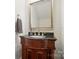 Well-lit bathroom featuring a wooden vanity with a granite countertop and framed mirror at 648 Revival Row, Fort Mill, SC 29708