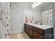 Bathroom with a single sink vanity, framed mirror, and patterned shower curtain at 648 Revival Row, Fort Mill, SC 29708
