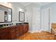 Bathroom with double sink vanity, tile floor and warm color scheme at 648 Revival Row, Fort Mill, SC 29708