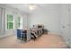 Bright bedroom with carpet, neutral walls, ceiling fan, and desk with a window view at 648 Revival Row, Fort Mill, SC 29708