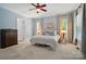 Bedroom with carpet, neutral walls, ceiling fan, and large windows offering natural light at 648 Revival Row, Fort Mill, SC 29708