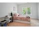 Cozy bedroom featuring neutral carpet, large window, and comfortable bed with plush pillows at 648 Revival Row, Fort Mill, SC 29708