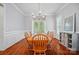 Traditional dining room with hardwood floors, wainscoting, and elegant chandelier lighting the table at 648 Revival Row, Fort Mill, SC 29708