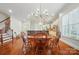 Spacious dining area showcasing an open floor plan with kitchen view and hardwood floors at 648 Revival Row, Fort Mill, SC 29708